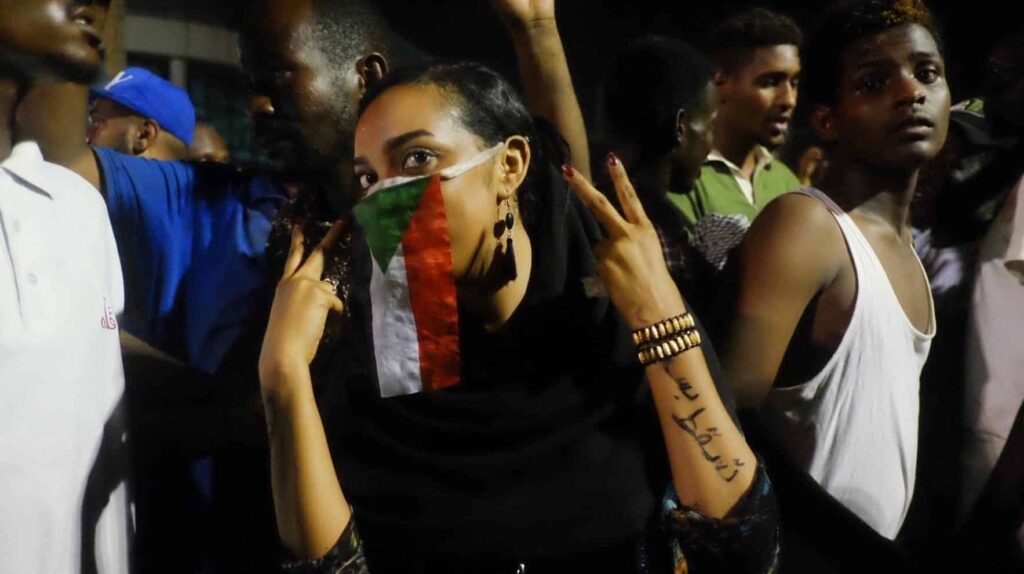 The woman above has written “Just Fall“ on her arm, reflecting the demonstrators' calls for President Omer Al Bashir and his government to resign. Image was taken in Khartoum Sudan during Sudan sit-in.