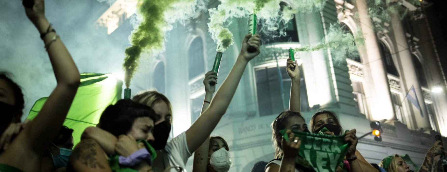 Argentinian Women with green pañuelos and green smoke from cannisterts held high protesting for abortion rights.