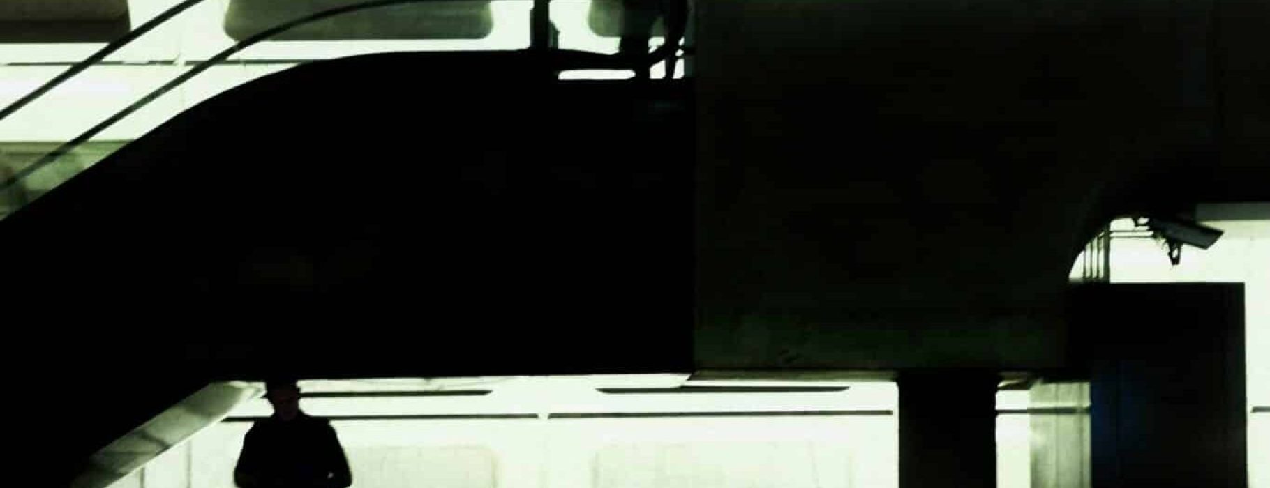 ivan-mani-5x3KdH6GZmo-unsplash Ivan Mani, "A person standing on a escalator in a train station"
