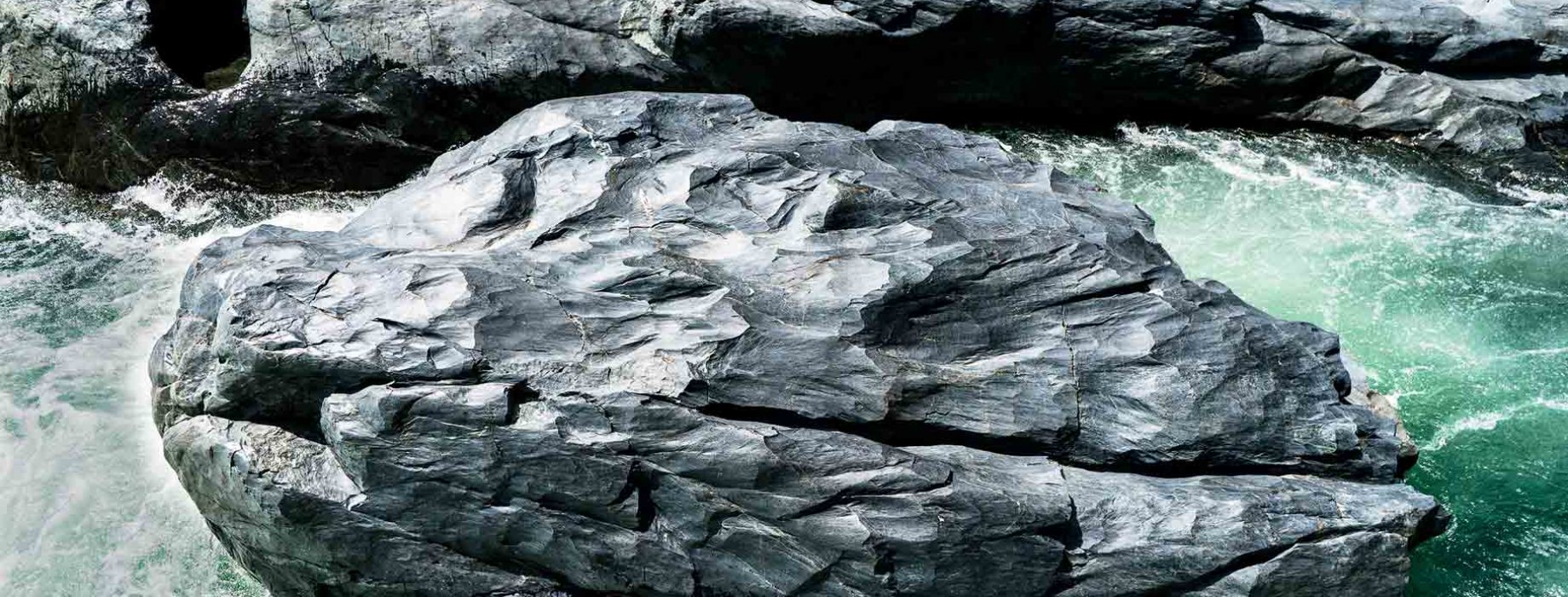 A river flows around a boulder